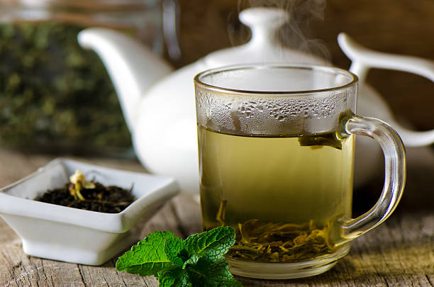 drinking green tea drinking green tea cups of green tea leaves