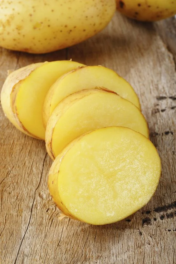 Potato slice on wooden background